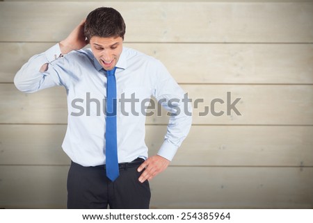 Thinking businessman scratching head against bleached wooden planks background