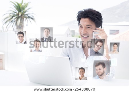 Smiling man using his laptop and talking on phone against profile pictures