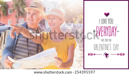 Happy tourist couple using map in the city against valentines day greeting