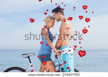 Cute couple together with their bicycles against red heart balloons floating