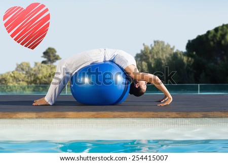 Peaceful brunette in cobra pose over exercise ball poolside against red heart