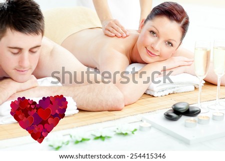 Attractive couple receiving a back massage against heart