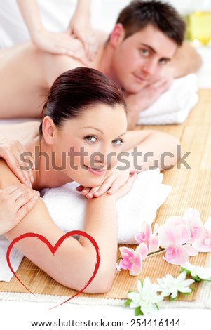 Merry young couple enjoying a back massage against heart