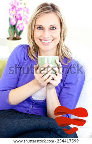 Blond woman enjoying her coffee sitting on the sofa in the livingroom against heart