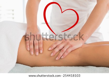 Close-up of a woman receiving leg massage against heart