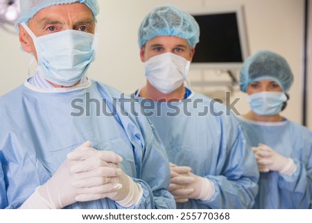 Medical student and lecturer looking at camera in scrubs at the university