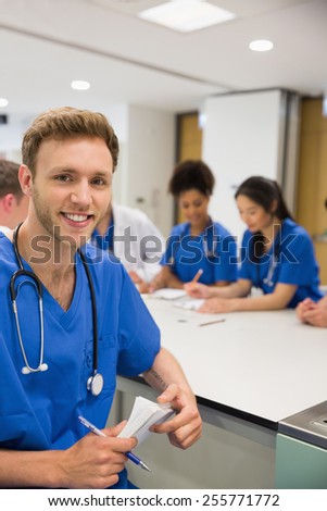 Medical student smiling at the camera during class at the university