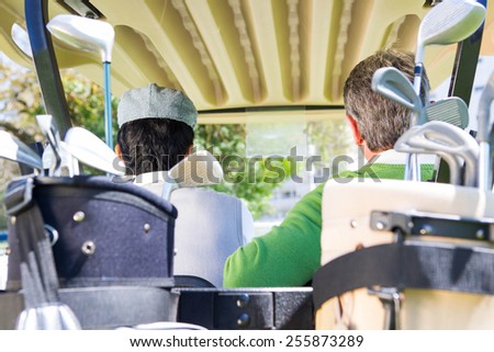 Golfing friends driving in their golf at the golf course
