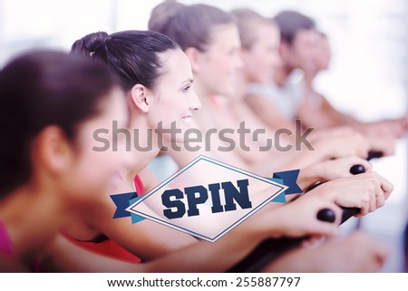 The word spin and fit young people working out at spinning class against badge
