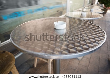 Bar stool and table with ash tray at the bakery