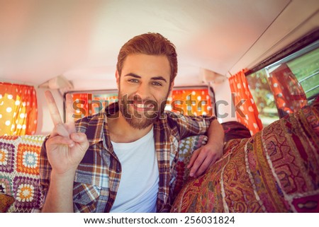 Hipster on road trip in camper van on a summers day
