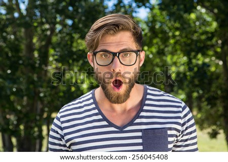 Shocked hipster looking at camera on a summers day