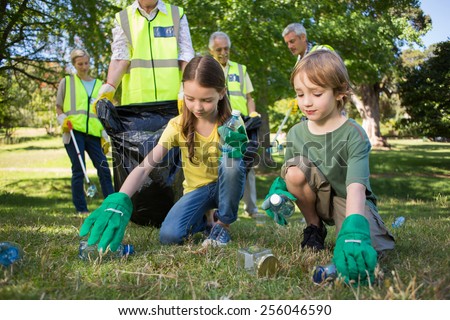 Similar – Image, Stock Photo Adult and children volunteers collecting garbage on the sea beach. Beach environment pollution. Tidying up rubbish on beach. People wear orange gloves picking garbage up in to yellow bag.