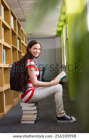 Student reading book in library at the university