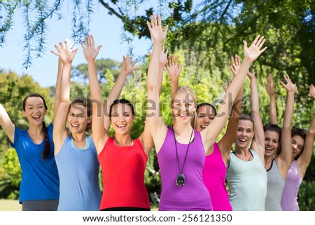 Fitness group smiling at camera in park on a sunny day