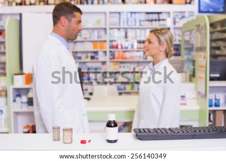 Pharmacists talking each other at the hospital pharmacy