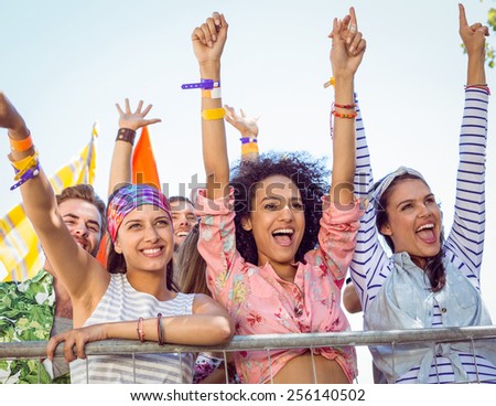 Happy hipsters listening to live music at a music festival