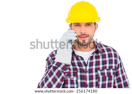 Repairman talking on mobile phone over white background