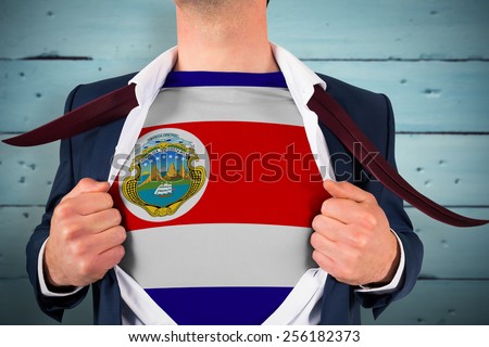Businessman opening shirt to reveal costa rica flag against painted blue wooden planks