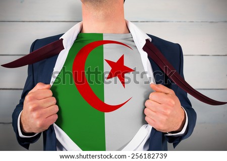 Businessman opening shirt to reveal algeria flag against painted blue wooden planks