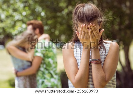 Brunette upset at seeing boyfriend with other girl on a summers day