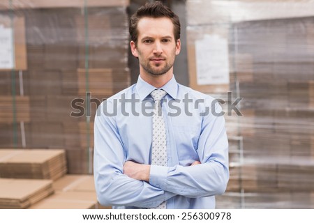 Portrait of serious male manager with arms crossed in warehouse