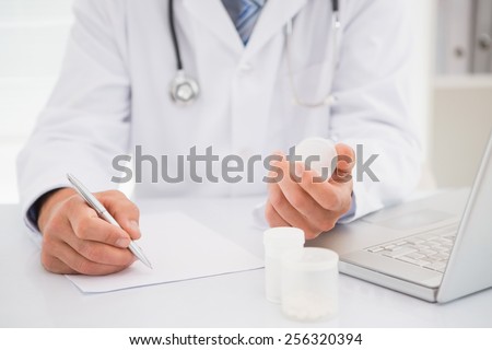 Vet writing on clipboard the prescriptions in medical office