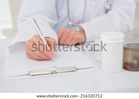 Vet writing on clipboard the prescriptions in medical office