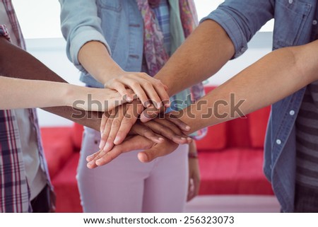 Fashion students putting hands together at the college