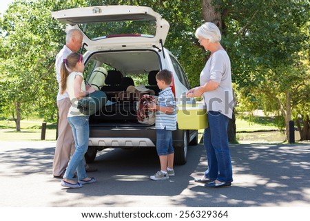 Grandparents going on road trip with grandchildren on a sunny day