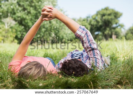 Cute couple holding hands in the park on a sunny day