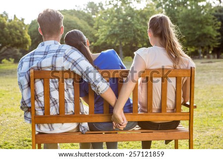 Man being unfaithful in the park on a sunny day