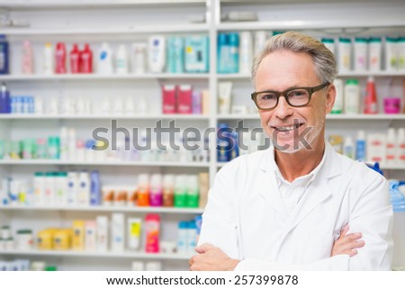 Senior pharmacist smiling at camera at the hospital pharmacy
