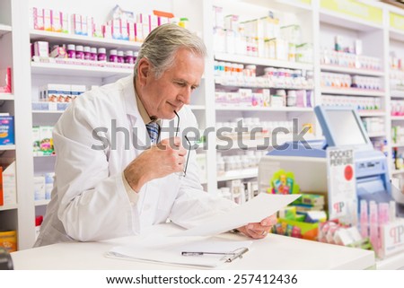 Senior pharmacist reading prescription in the pharmacy