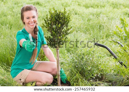 Young woman gardening for the community on a sunny day