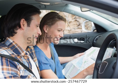 Couple looking at the map in their car