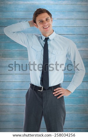 Thoughtful businessman with hand on head against wooden planks