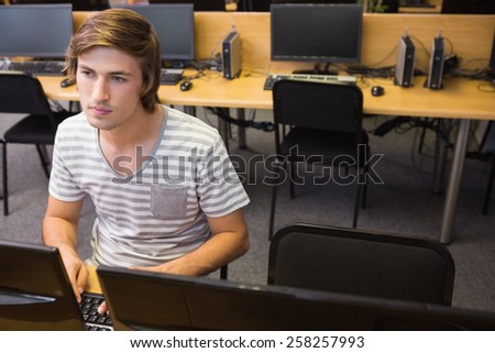 Student working on computer in classroom at the university