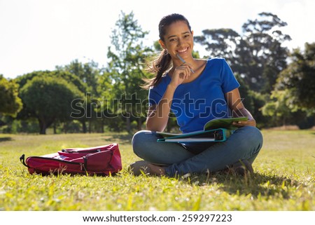 Pretty student studying outside on a sunny day