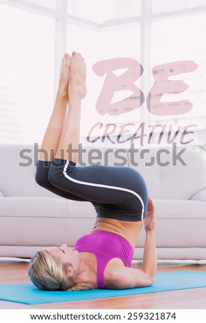 Slim blonde lifting her legs and hips on exercise mat against be creative