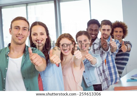 Fashion students showing thumbs up at the college