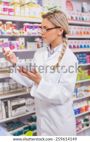 Student looking at prescription and medicine in the pharmacy