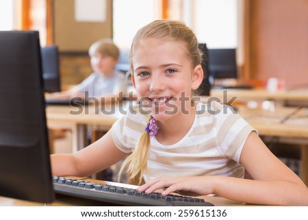 Cute pupil in computer class at the elementary school