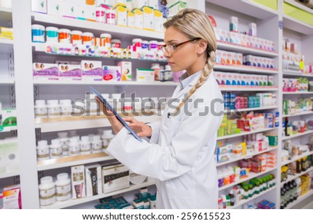 Concentrated student using tablet pc in the pharmacy