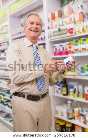Smiling customer showing a medicine in the pharmacy