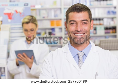 Happy pharmacist looking at camera at the hospital pharmacy
