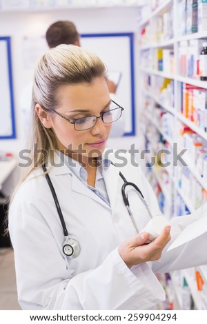 Pharmacist taking medicine from shelf at the hospital pharmacy