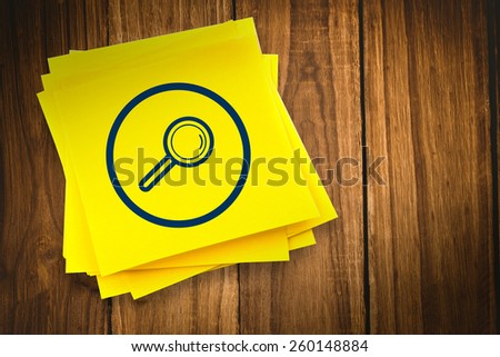 Magnifying glass graphic against sticky note