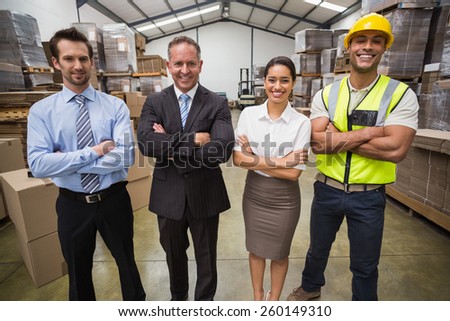 Warehouse team smiling at camera in warehouse