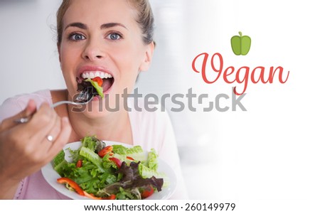 The word vegan against casual blonde posing while eating salad